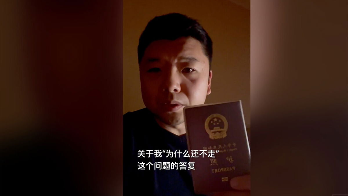 <i>Courtesy Wang Jixian</i><br/>Wang Jixian holding his Chinese passport in a video posted to Douyin
