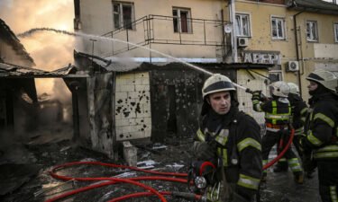 Firefighters extinguish a fire after shelling in Kyiv