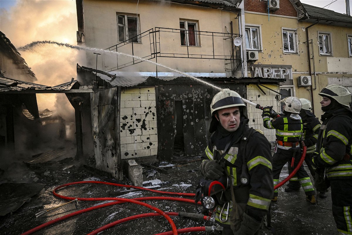 <i>Aris Messinis/AFP/Getty Images</i><br/>Firefighters extinguish a fire after shelling in Kyiv