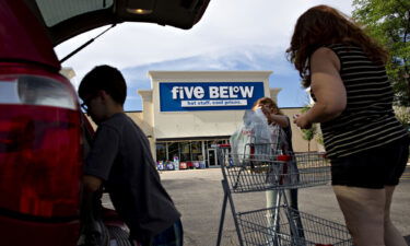 Shoppers place purchases into vehicles outside a Five Below store in Bloomington