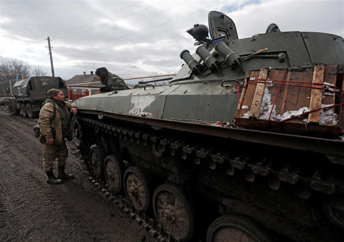 <i>Alexander Ermochenko/Reuters</i><br/>Troops in uniforms without insignia are seen next to an armored vehicle with the symbol 