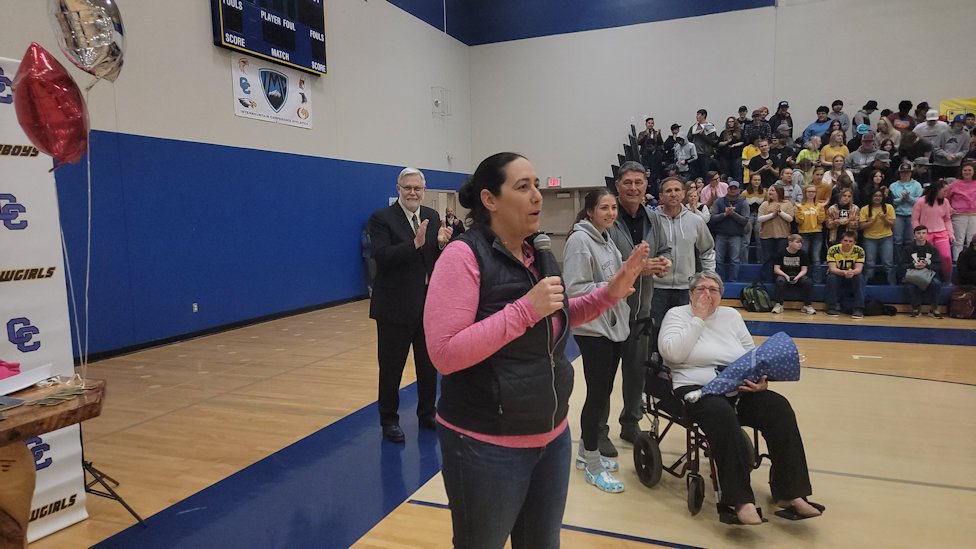 Crook County High School Michelle Jonas, her family at her side, speaks to applauding students at assembly Monday, as she was named Oregon Principal of the Year