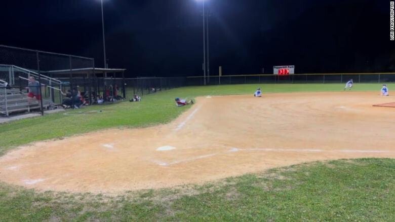 <i>Lori Ferguson/TMX</i><br/>Players drop to the ground as gunfire is heard during a youth baseball game in North Charleston