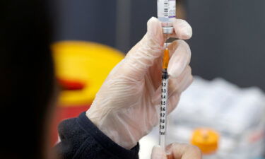 A medic prepares a dose of the Pfizer-BioNTech vaccine against the coronavirus at a private nursing home.