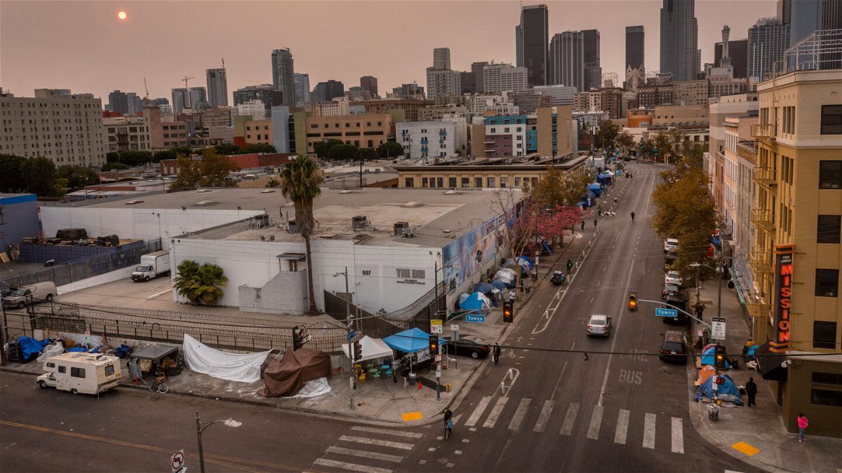 <i>Allen J. Schaben/Los Angeles Times via Getty Images</i><br/>An aerial view of homeless encampments in Skid Row as smoke from California wildfires obscures the setting sun and skyline in 2021 in Los Angeles