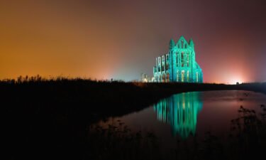The historic Whitby Abbey is seen illuminated on October 27