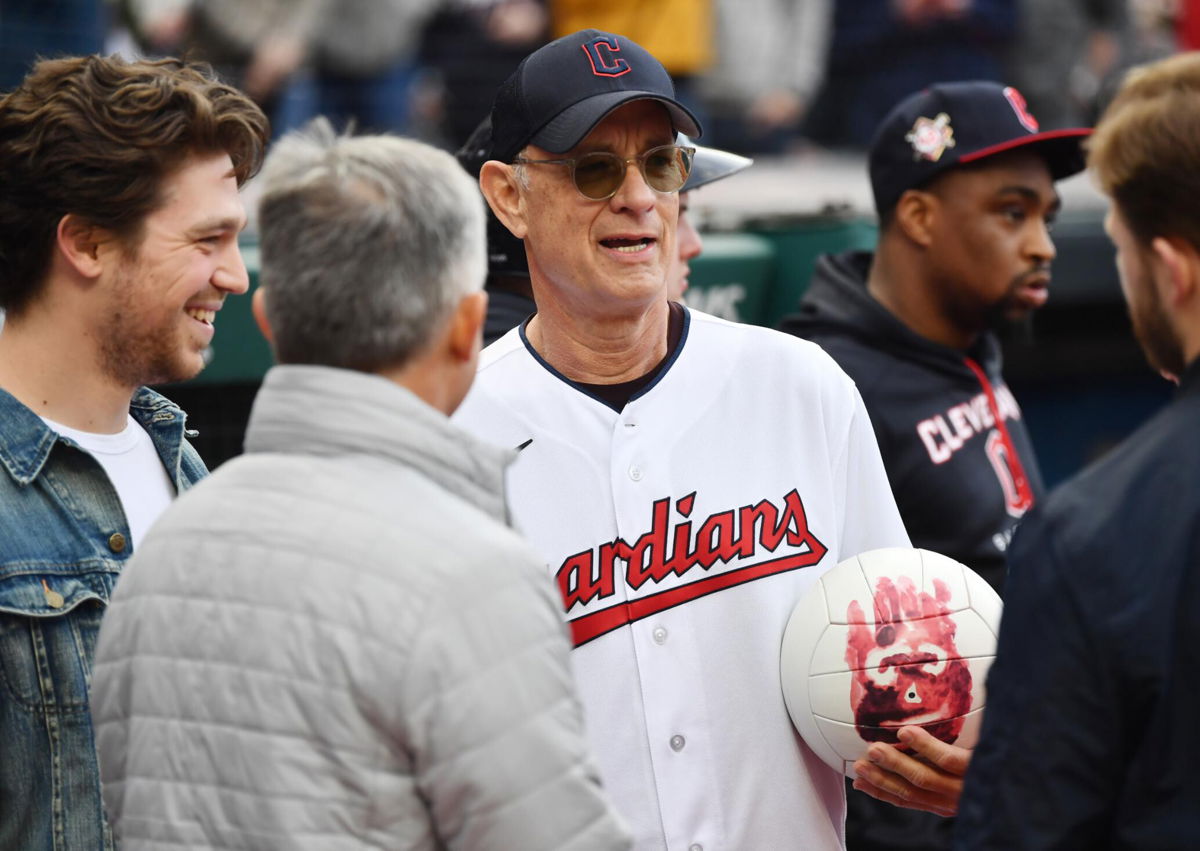 <i>Ken Blaze/USA Today Sports</i><br/>Actor Tom Hanks holds Wilson the volleyball from his film Cast Away before the game between the Cleveland Guardians and the San Francisco Giants at Progressive Field.