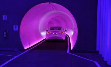 A Tesla car drives through a tunnel in the Central Station during a media preview of the Las Vegas Convention Center Loop on April 9