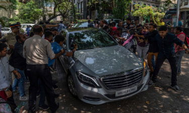 Members of the media jostle for photographs and footage of guests arriving to attend a function ahead of Kapoor and Bhatt's wedding.