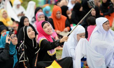 Young Muslims devotees take a "selfie" prior to Friday prayers to mark the end of Ramadan last year in Manila