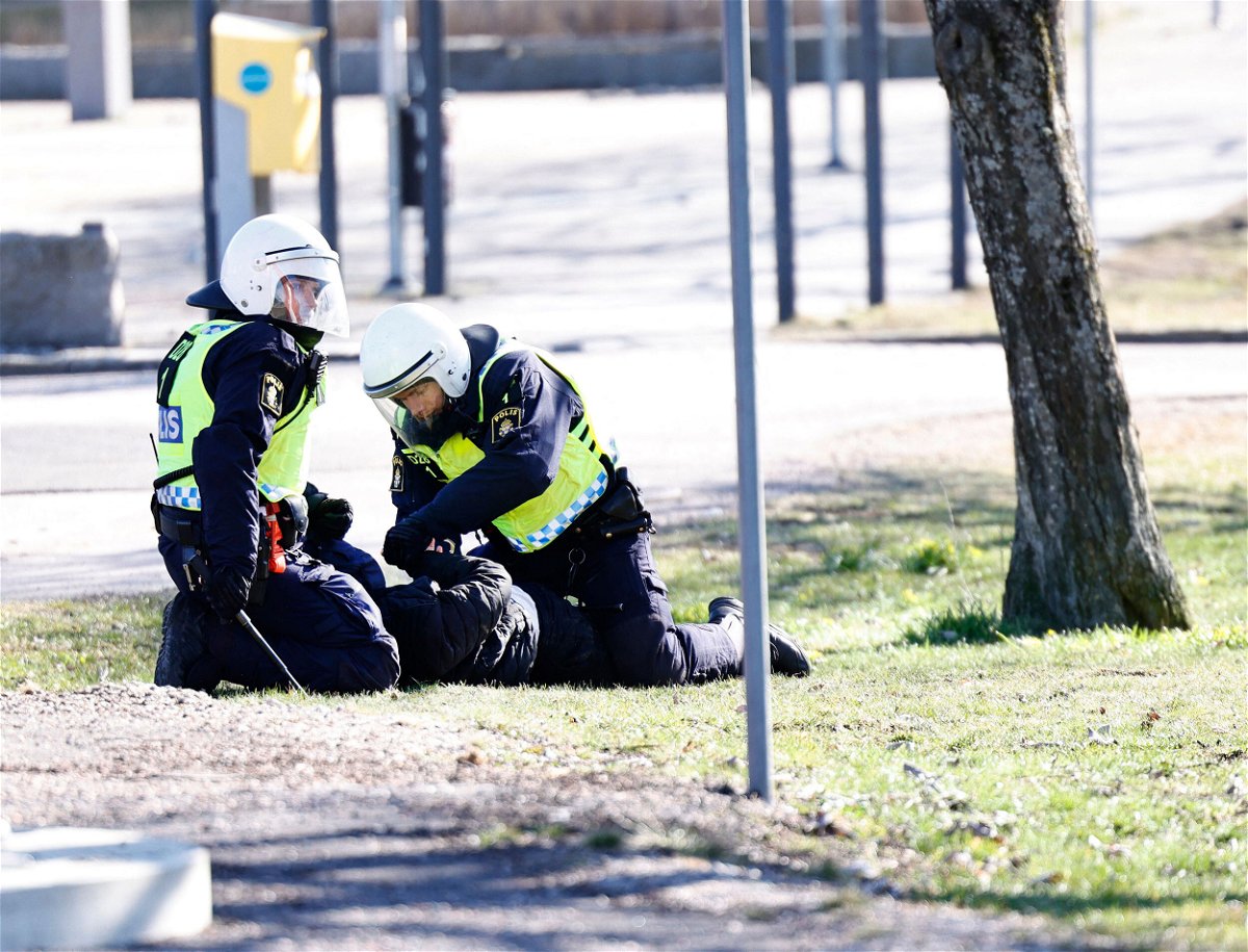 <i>Stefan Jerrevang/AFP/Getty Images</i><br/>Police arrest a protester during rioting in Norrköping. Dozens injured in riots in Sweden after Quran burnings.