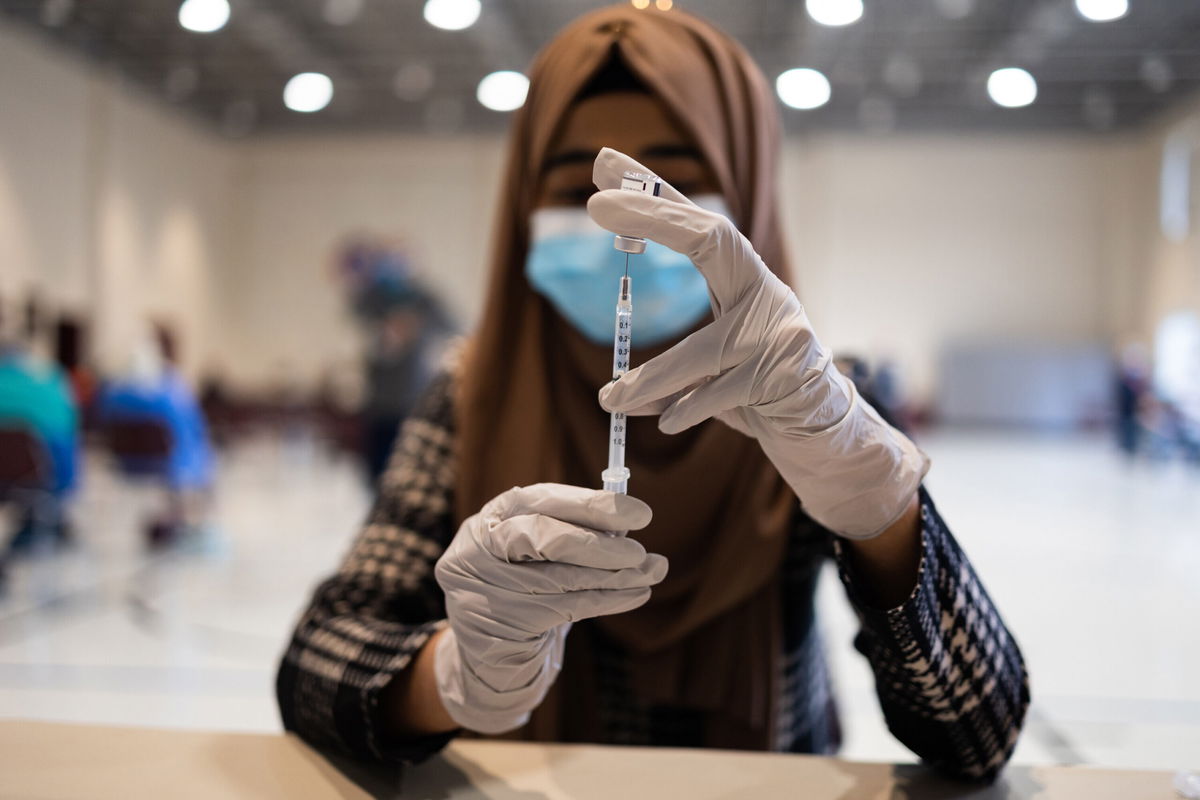 <i>Hannah Beier/Bloomberg/Getty Images</i><br/>A healthcare worker prepares a dose of a Covid-19 booster shot at a vaccine clinic in Lansdale