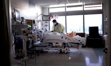 Respiratory Therapist Nirali Patel works with a COVID-19 patient in the ICU at Rush University Medical Center on January 31 in Chicago.