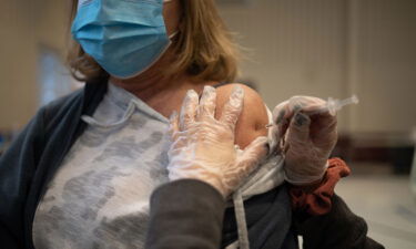 A resident receives a Covid-19 booster shot at a vaccine clinic inside Trinity Evangelic Lutheran Church in Lansdale