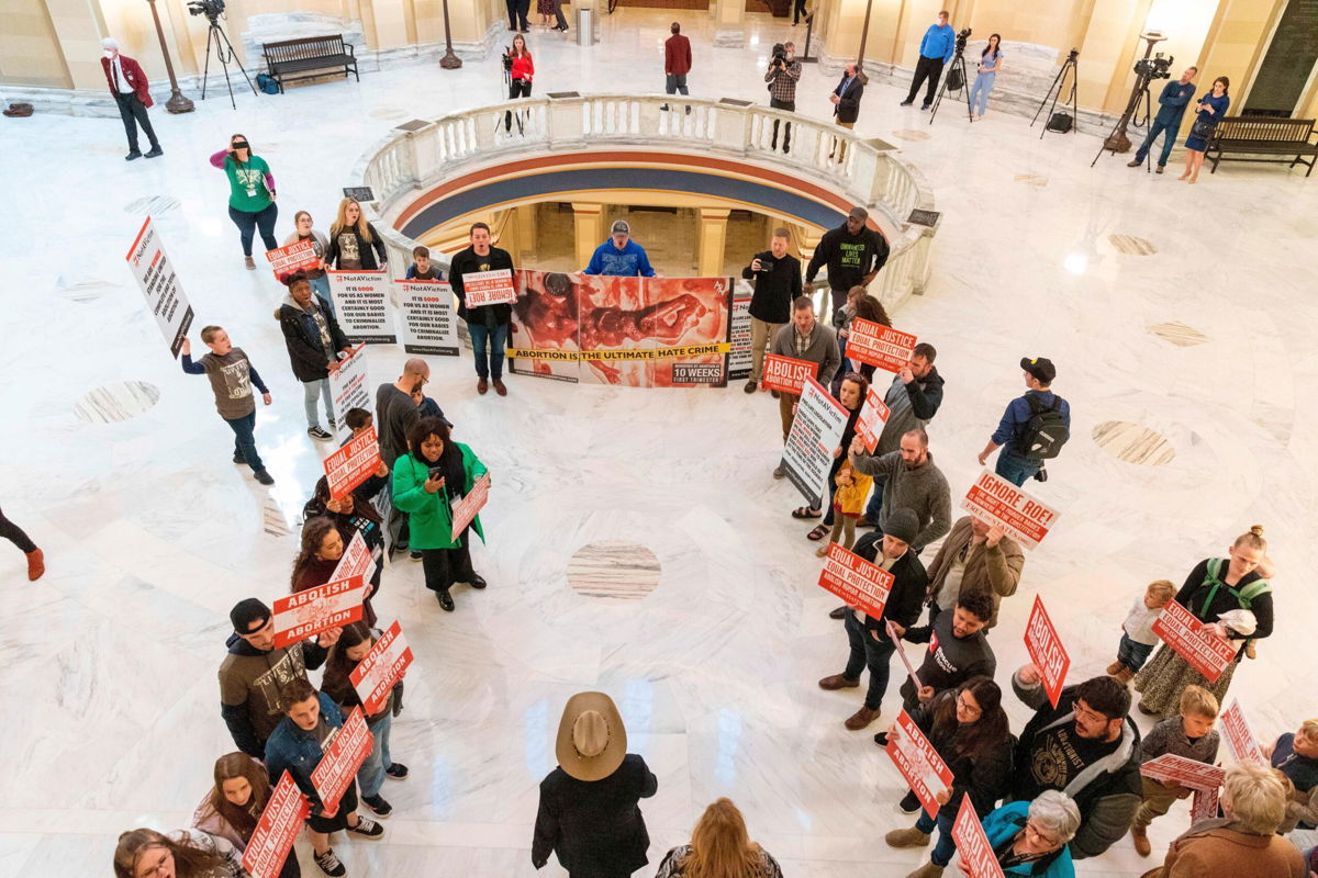 <i>Alonzo Adams/AP</i><br/>Anti-abortion activists stand outside the Oklahoma House chamber in Oklahoma City where Gov. Kevin Stitt delivers his State of the State address on February 7.