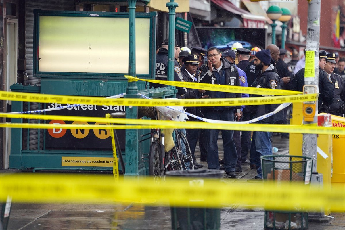 <i>John Minchillo/AP/FILE</i><br/>NYPD personnel gather at the entrance to a subway stop in Brooklyn on April 12. The suspect in the Brooklyn subway shooting was denied bail on April 14