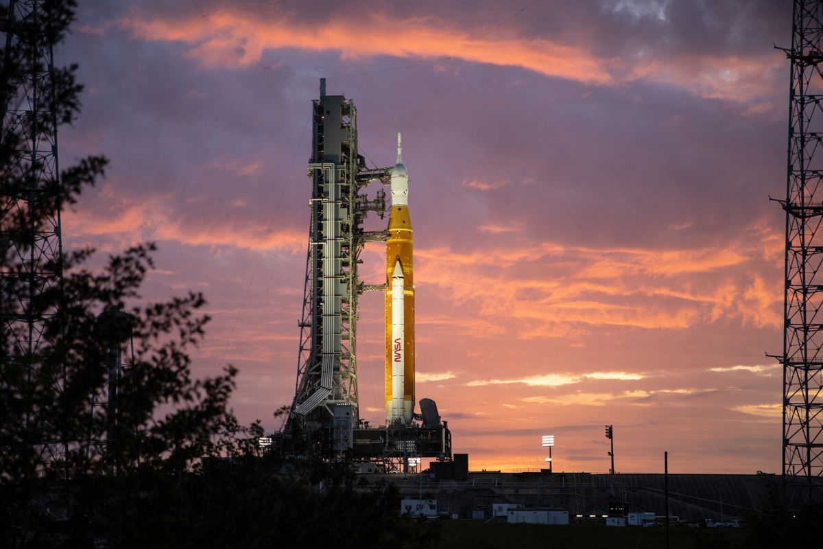 <i>Ben Smegelsky/NASA</i><br/>The Artemis I rocket stack can be seen at sunrise on March 23 at Kennedy Space Center in Florida. The final