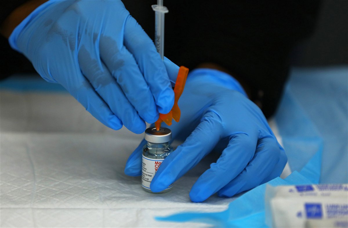 <i>Pat Greenhouse/The Boston Globe/Getty Images</i><br/>A dose of the Moderna COVID-19 Vaccine is prepared at a COVID-19 testing and vaccination site in Boston.