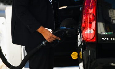 US fuel economy rules will soon require 49 mpg average. A customer pumps gasoline in  Los Angeles