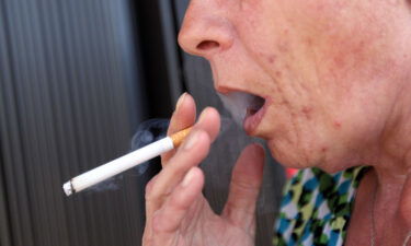 Brenda Wisehart smokes a menthol cigarette in front of a Quick Stop store on March 30