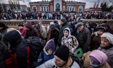 Families walk on a platform to board a train at Kramatorsk central station as they flee the eastern city on April 5.