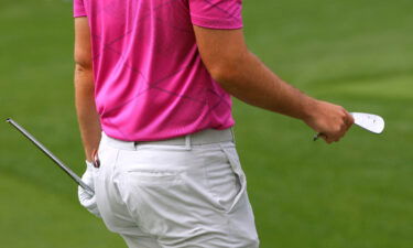 Wolff holds a broken club after breaking it after his tee shot on the fourth hole.