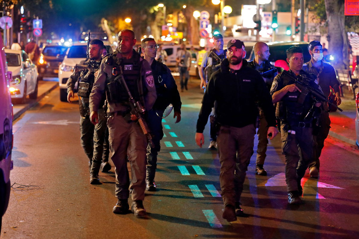 <i>Ahmad Gharabli/AFP/Getty Images</i><br/>Israeli security forces gather at the scene of a shooting on Dizengoff Street in Tel Aviv on Thursday.