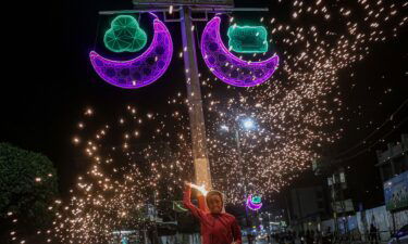 A Palestinian child waves fireworks on April 2