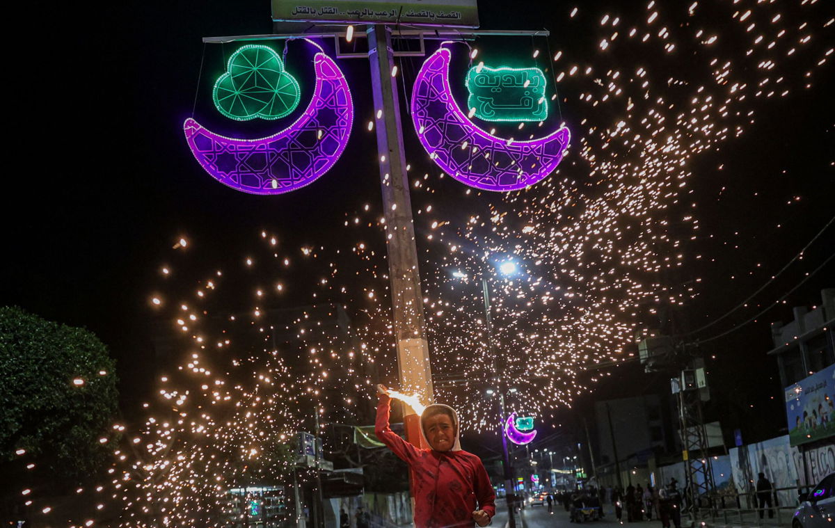 <i>SAID KHATIB/AFP/Getty Images</i><br/>A Palestinian child waves fireworks on April 2