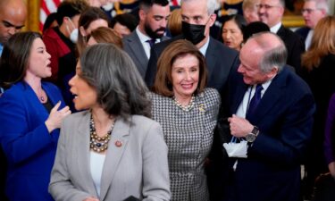 House Speaker Nancy Pelosi works her way through the crowd at the conclusion of an Affordable Care Act event in the East Room of the White House in Washington