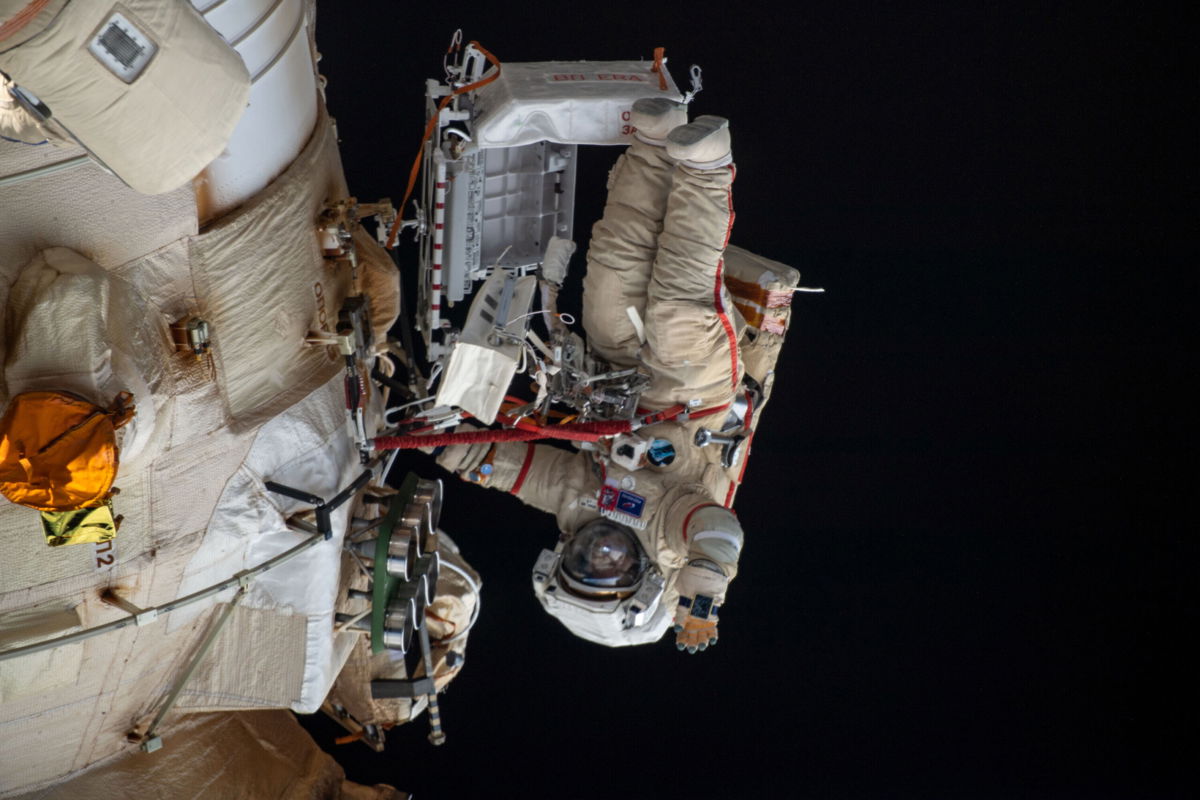 <i>NASA</i><br/>Cosmonaut Oleg Artemyev waves to the camera while working outside the Nauka multipurpose laboratory module during a spacewalk that lasted for six hours and 37 minutes to outfit Nauka and configure the European robotic arm on the International Space Station's Russian segment.