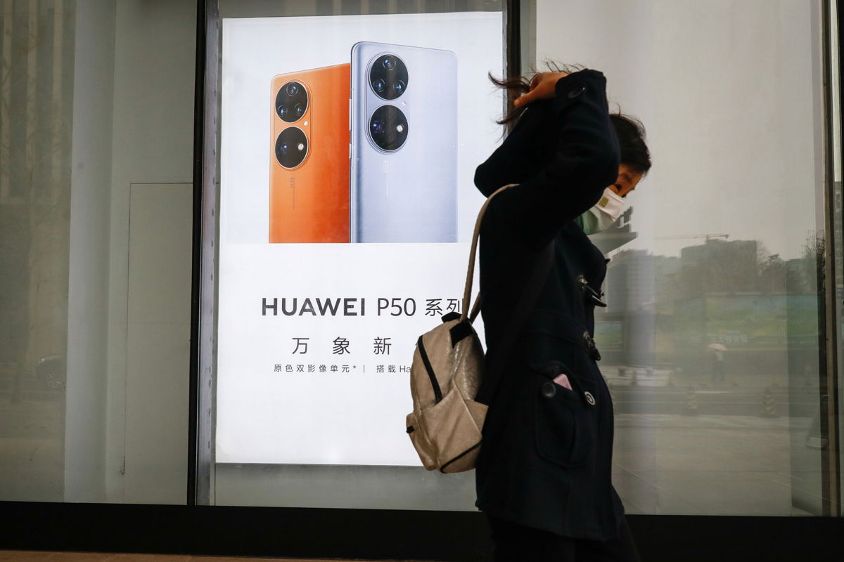<i>MARK R CRISTINO/EPA-EFE/Shutterstock</i><br/>A woman walks past a Huawei advertisement in Beijing