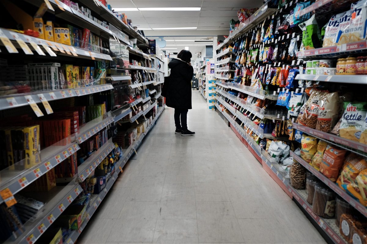 <i>Spencer Platt/Getty Images</i><br/>People shop in a store in Brooklyn on March 10 in New York City. The price of gas