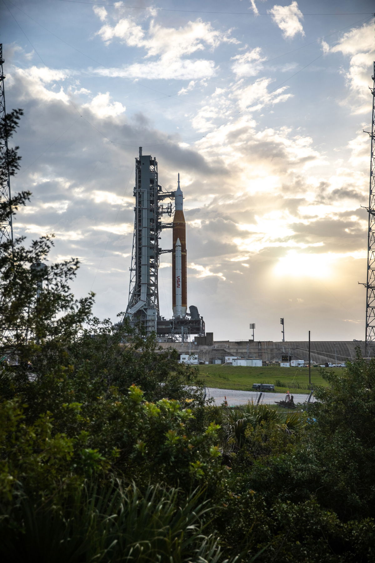 <i>Ben Smegelsky/NASA</i><br/>Blue sky and clouds serve as the backdrop for a sunrise view of the Artemis I Space Launch System (SLS) and Orion spacecraft at Launch Pad 39B at NASA's Kennedy Space Center in Florida on March 23.