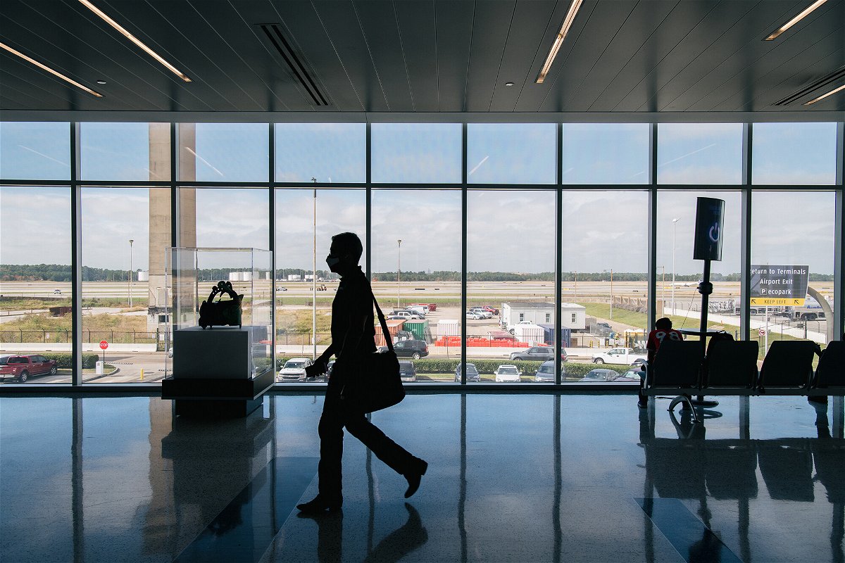 <i>Brandon Bell/Getty Images</i><br/>A traveler walks through the George Bush Intercontinental Airport on December 03