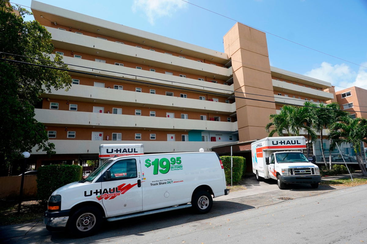 <i>Wilfredo Lee/AP</i><br/>Moving vans and trucks are parked outside the Bayview 60 Homes apartment building in North Miami Beach