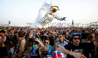 Concertgoers dance around a large-scale moving sculpture called "Escape Velocity" at Coachella in 2014. The festival will be streaming online courtesy of Coachella's channel on YouTube.