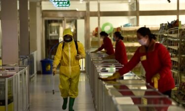 Employees spray disinfectant and wipe surfaces as part of preventative measures against the Covid-19 coronavirus at the Pyongyang Children's Department Store in Pyongyang on March 18.
