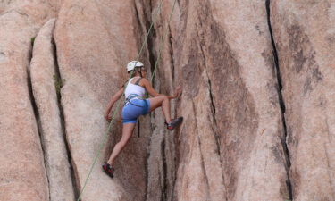 Rock climbing brings unexpected benefits. A rock climber is seem here getting a workout by ascending Intersection Rock in Joshua Tree National Park in California.