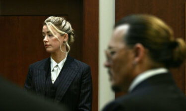 Amber Heard and Johnny Depp watch as the jury comes into the courtroom on on May 17.