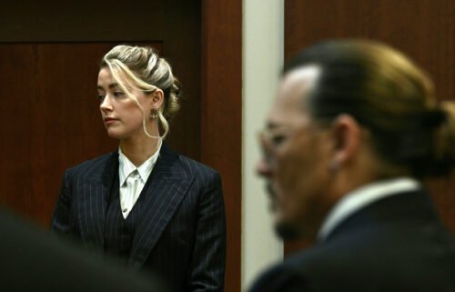 Amber Heard and Johnny Depp watch as the jury comes into the courtroom on on May 17.