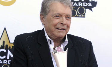 Mickey Gilley poses with the Triple Crown Award on the red carpet at the 50th annual Academy of Country Music Awards at AT&T Stadium in Arlington