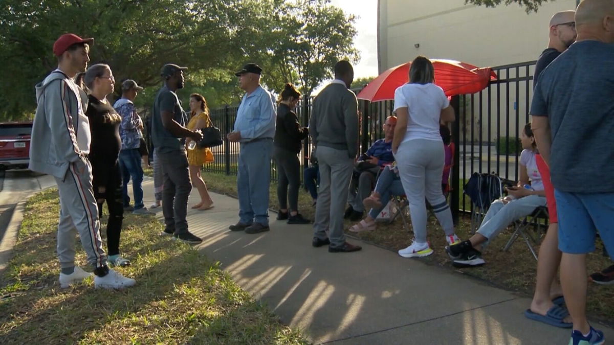 <i>WESH</i><br/>People wait outside the US Immigration and Customs Enforcement office in Orlando