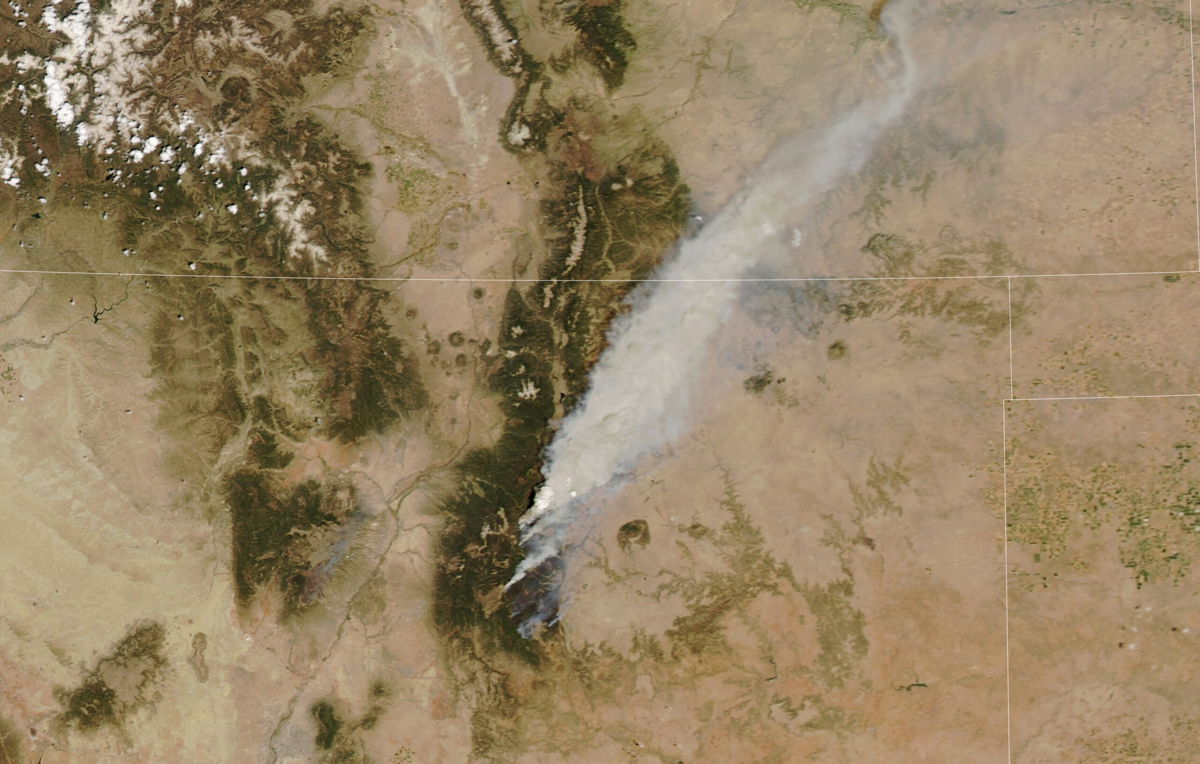 <i>NASA Aqua MODIS</i><br/>This image of the Hermit's Peak/Calf Canyon Fire was taken from space on May 10 and shows a pyrocumulonimbus cloud forming on the northern side of the fire.