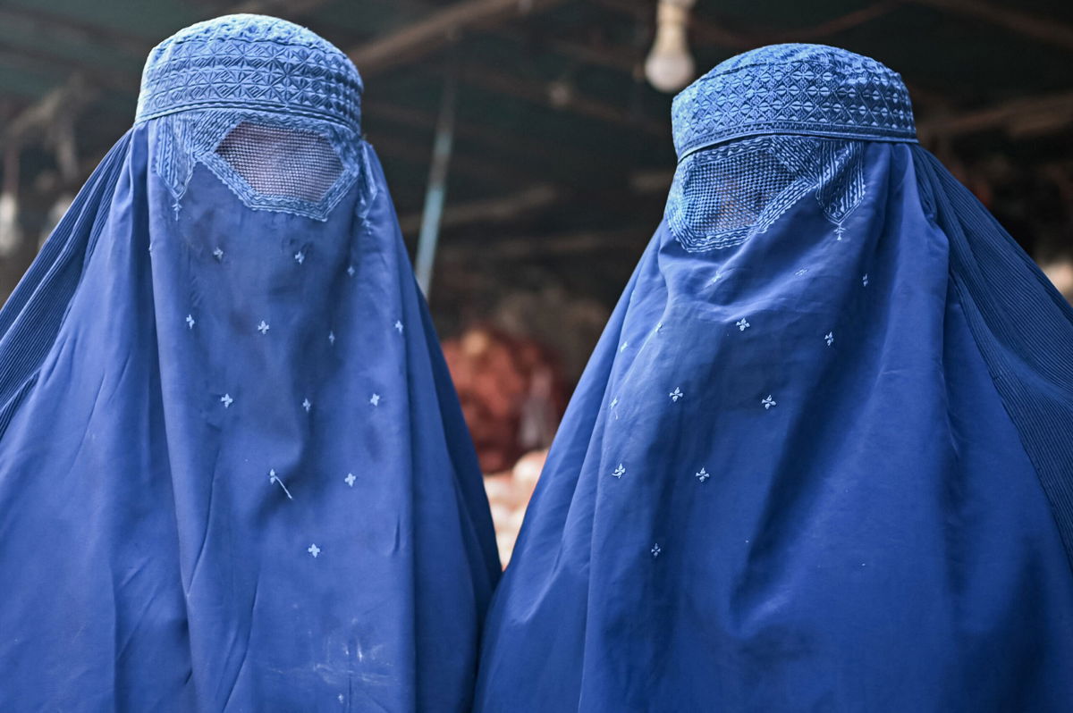 <i>Mohd Rasfan/AFP/Getty Images</i><br/>Taliban decree orders women in Afghanistan to cover their faces. Afghan burqa-clad women are pictured at a market in Kabul on December 20