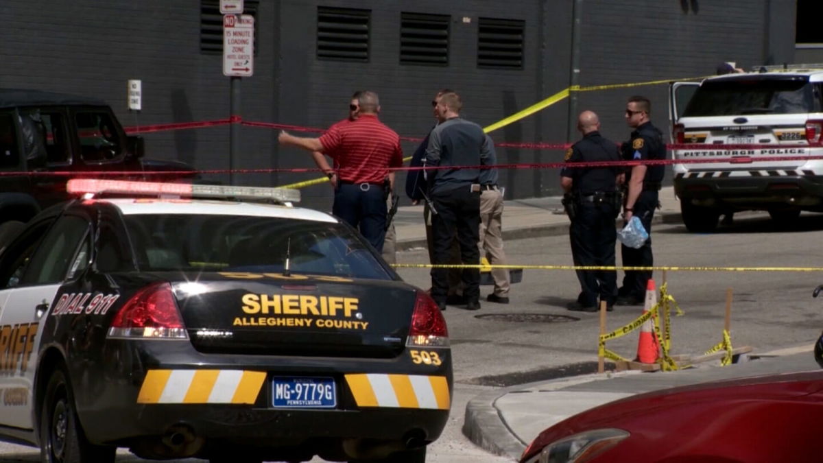 <i>WTAE</i><br/>Police investigate the scene of a drive-by shooting in downtown Pittsburgh on May 29.