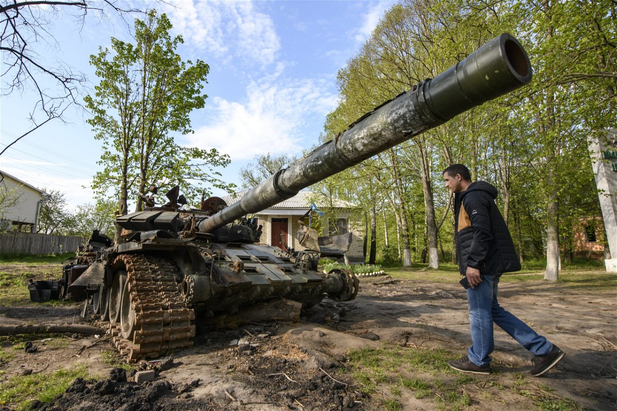 <i>Maxym Marusenko/NurPhoto/Getty Images</i><br/>Local resident looks at the Russian military tank destroyed during Russia's invasion in Ukraine