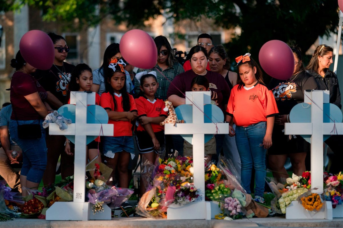 <i>Jae C. Hong/AP</i><br/>People gather at a memorial site to pay their respects for the victims killed in this week's elementary school shooting in Uvalde