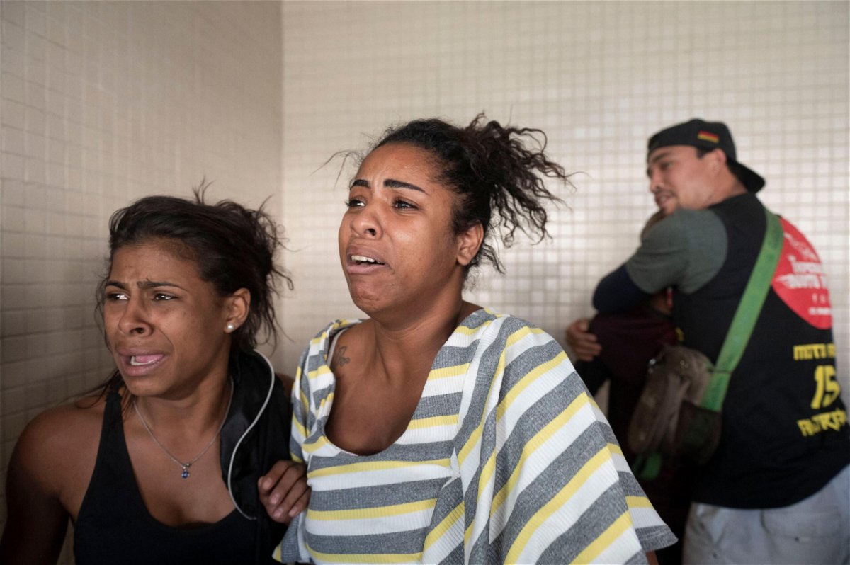 <i>Mauro Pimentel/AFP/Getty Images</i><br/>People react as victims arrive at the Getulio Vargas Hospital on May 24.