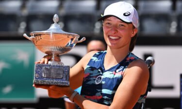 Iga Swiatek poses with the winner's trophy after defeating Tunisia's Ons Jabeur to win the final of the Women's WTA Rome Open tennis tournament on May 15.